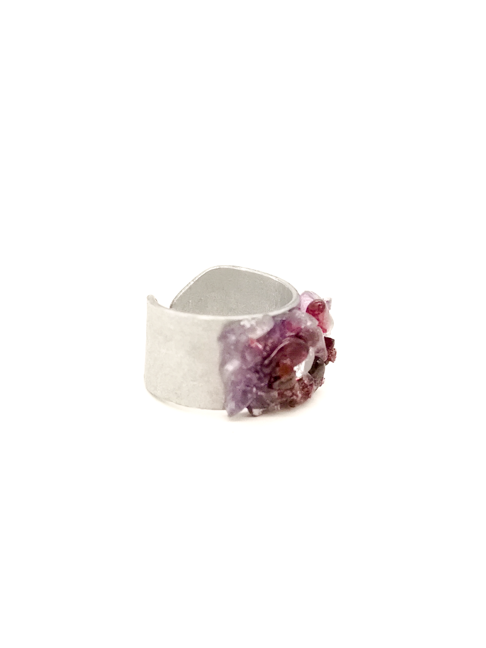 Silver ring with purple gemstone on a white background