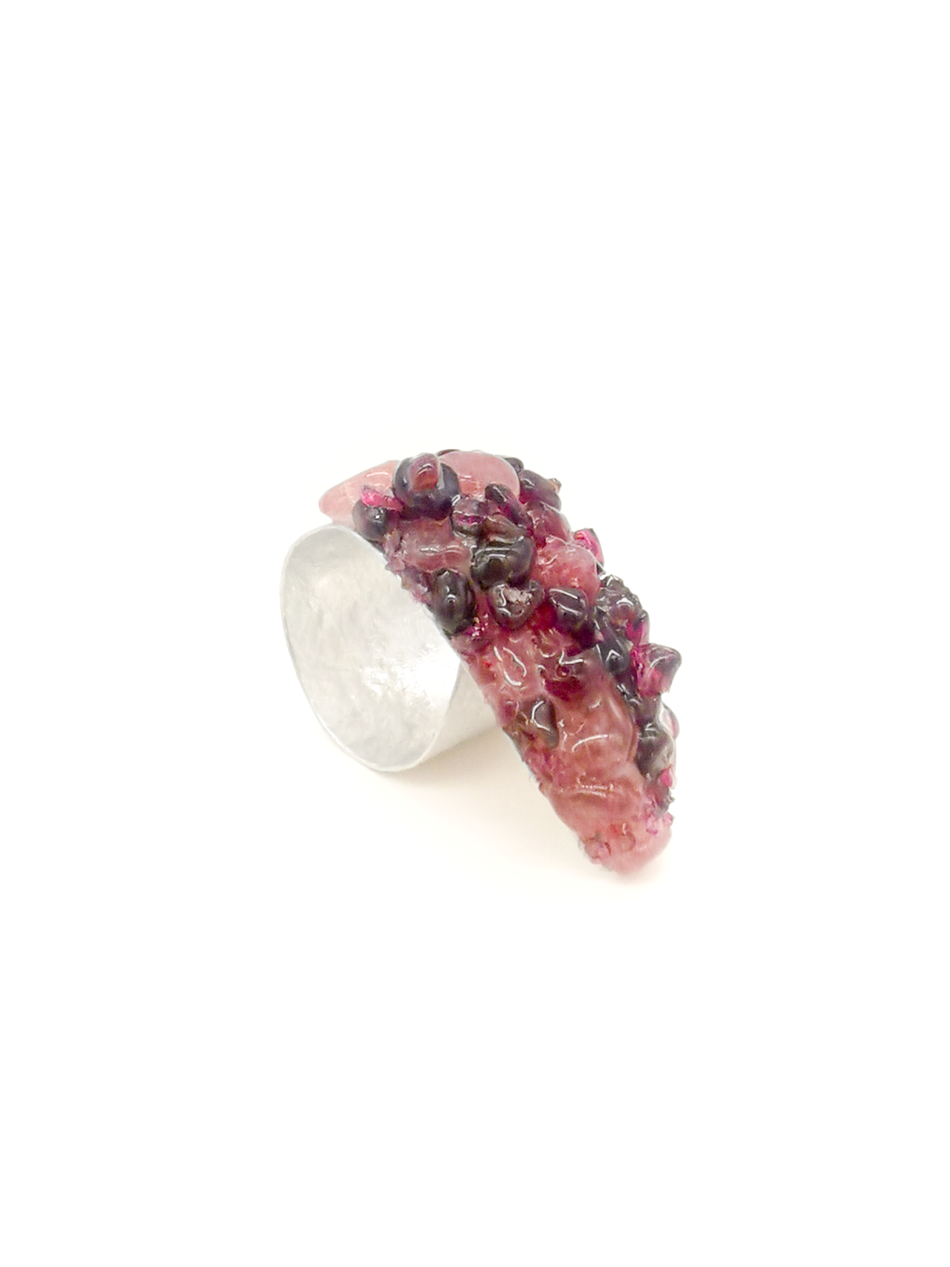 Silver ring with pink gemstone on a white background