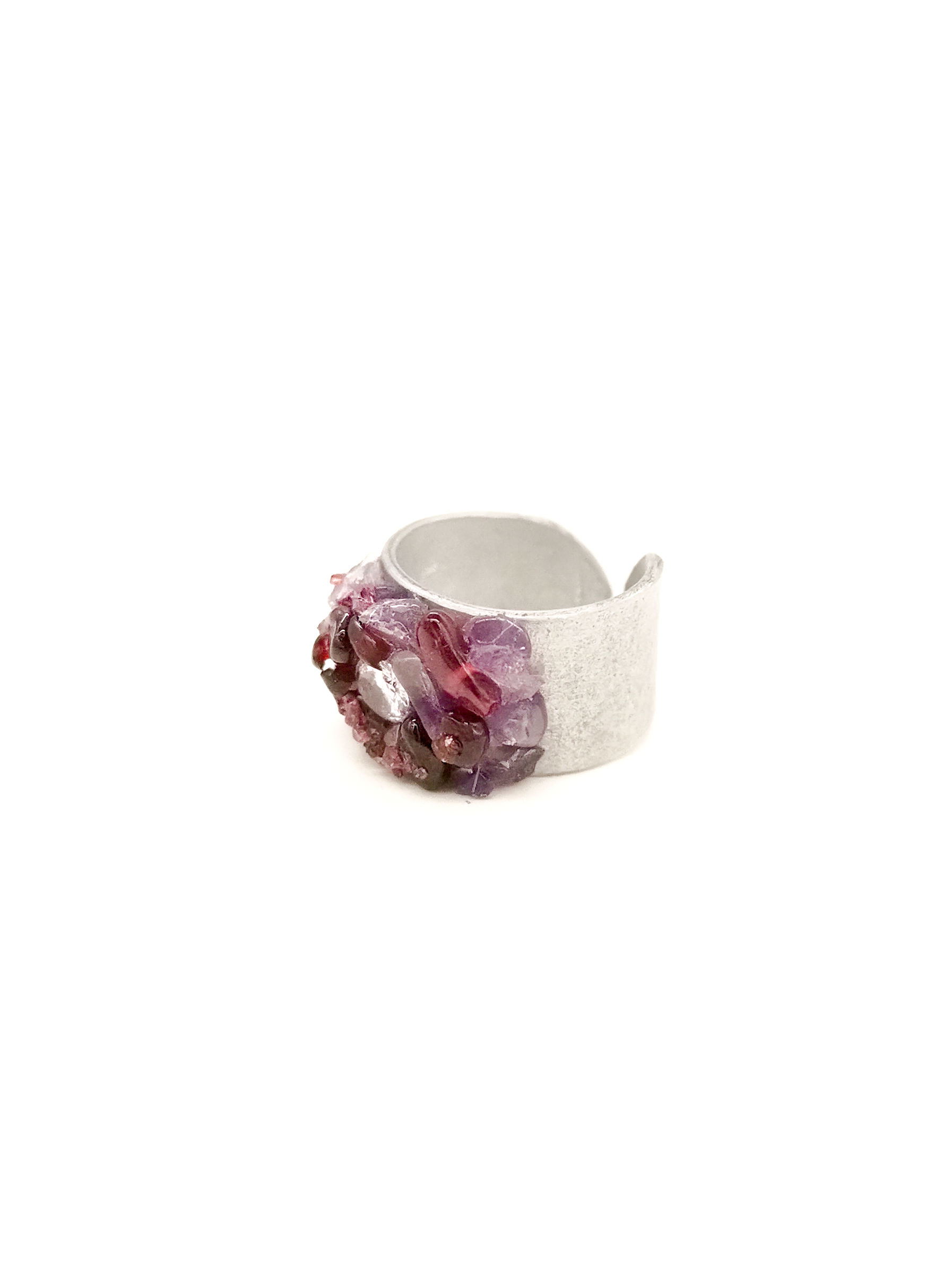Silver ring with purple gemstone on a white background