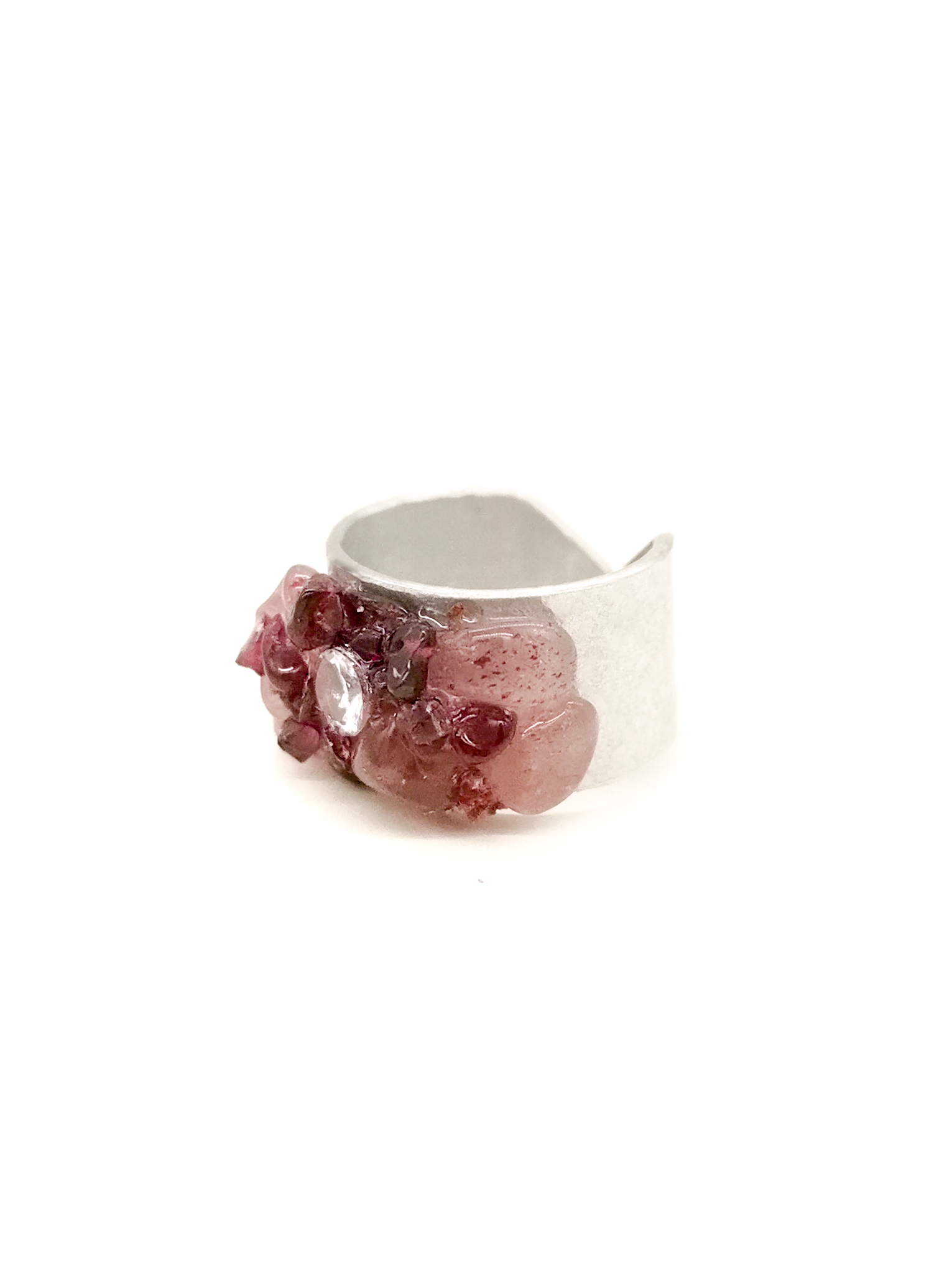 Silver ring with pink gemstone on a white background