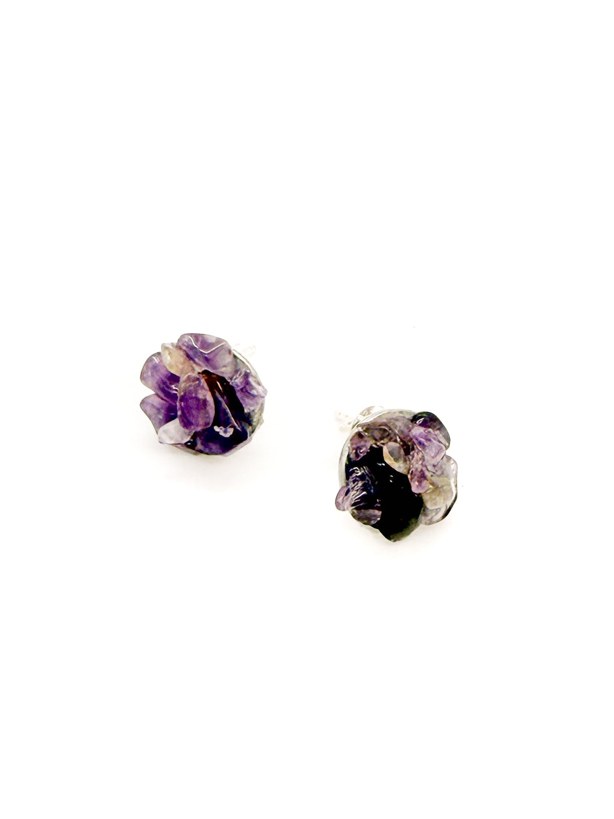 Pair of purple and black stud earrings on a white background